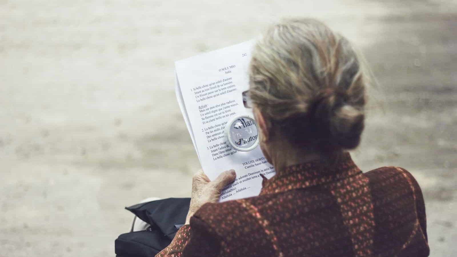 woman in brown top reading paper