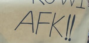 person holding AFK signage