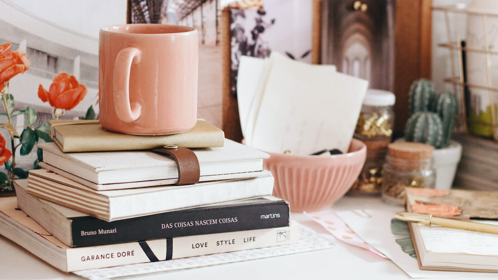 brown ceramic coffee mug on book