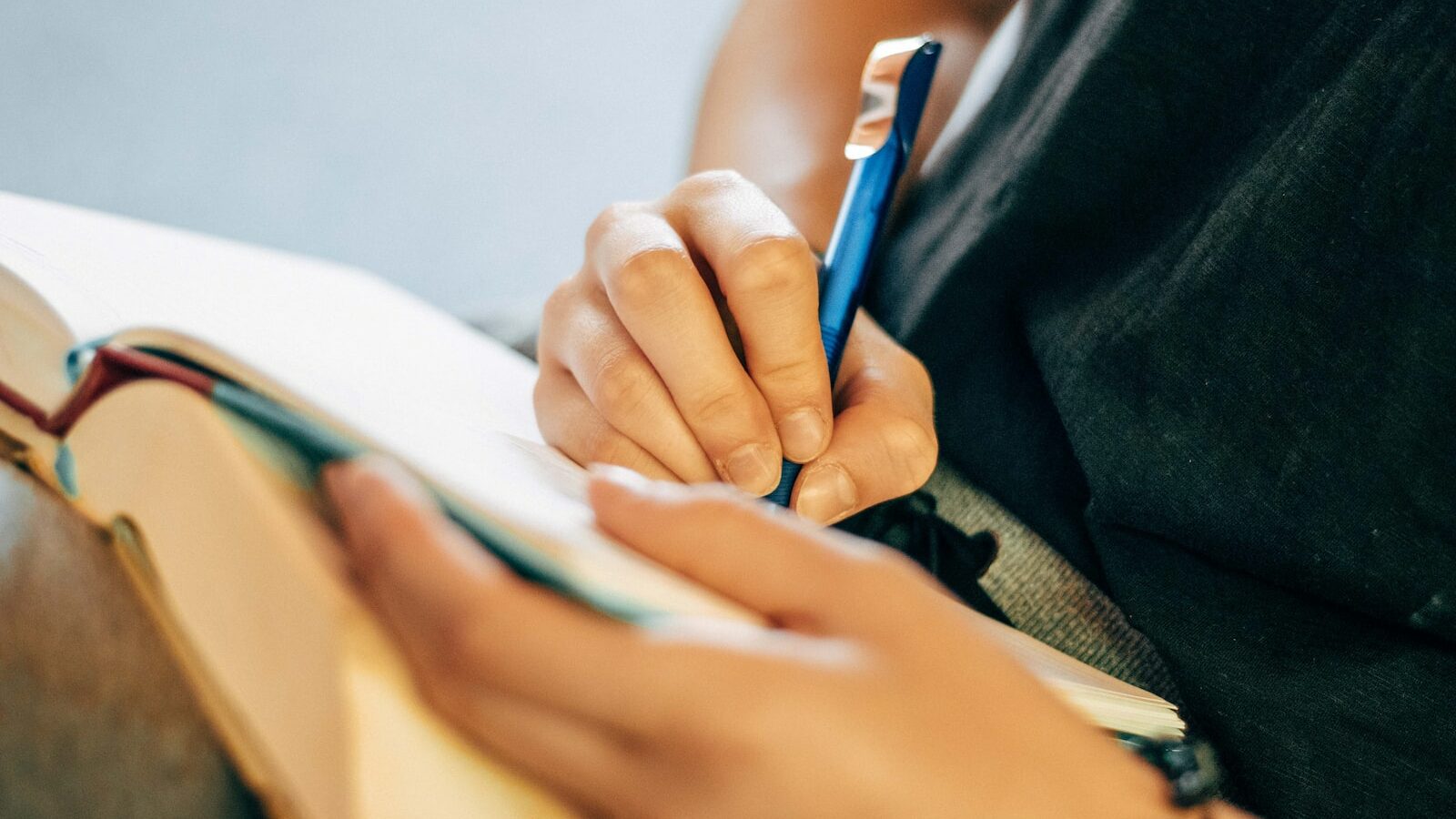 shallow focus photo of person writing