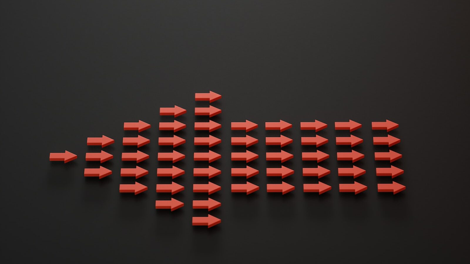 a group of red arrows on a black surface