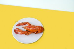 cooked lobster on ceramic plate
