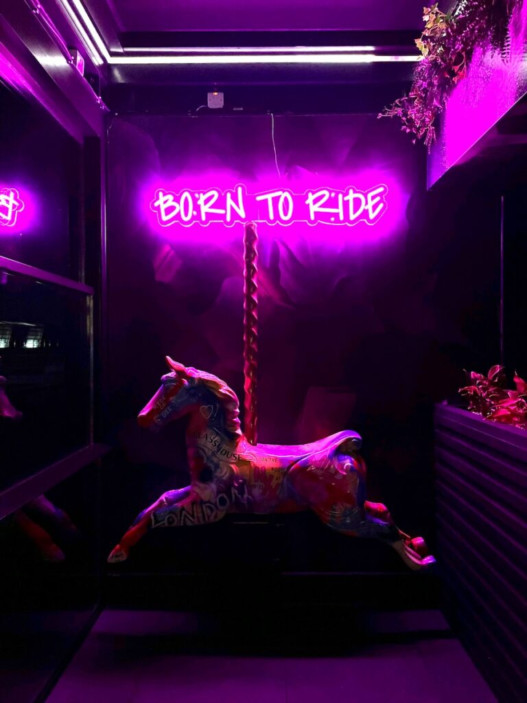a neon sign that reads born to ride